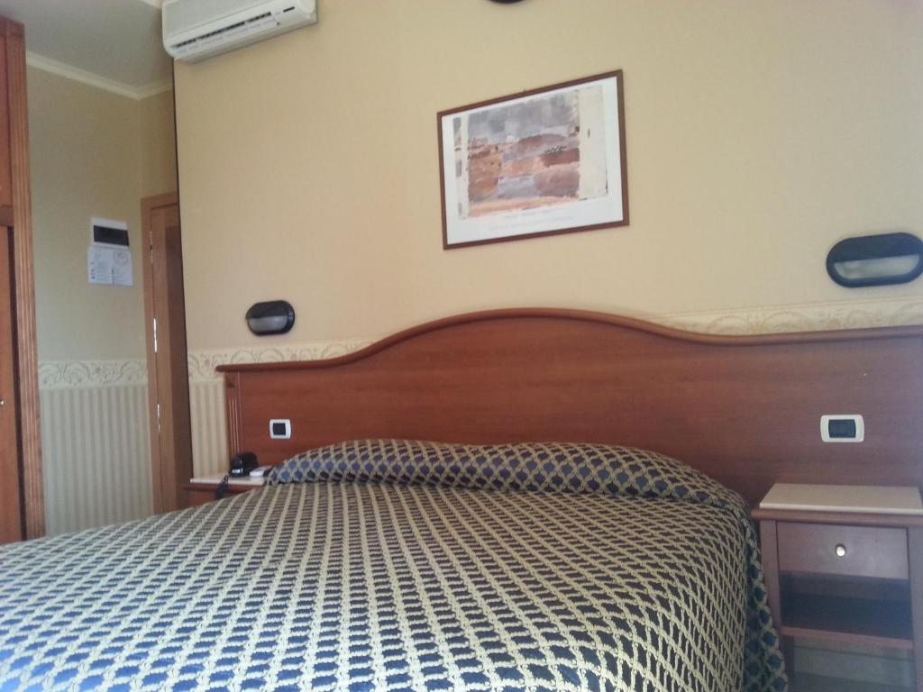 Postel nebo postele na pokoji v ubytování Hotel Grifone