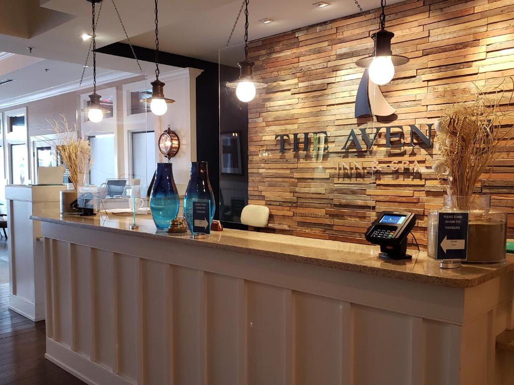 a bar with a sign that reads the agency at Avenue Inn & Spa in Rehoboth Beach