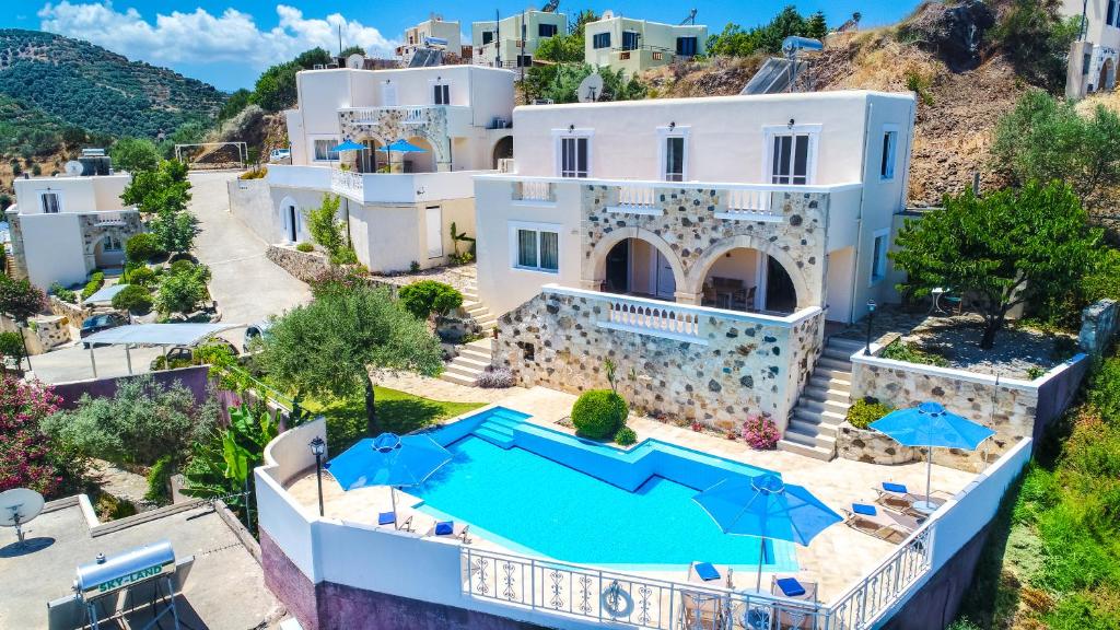 an aerial view of a villa with a swimming pool at Ilios Village in Stalos