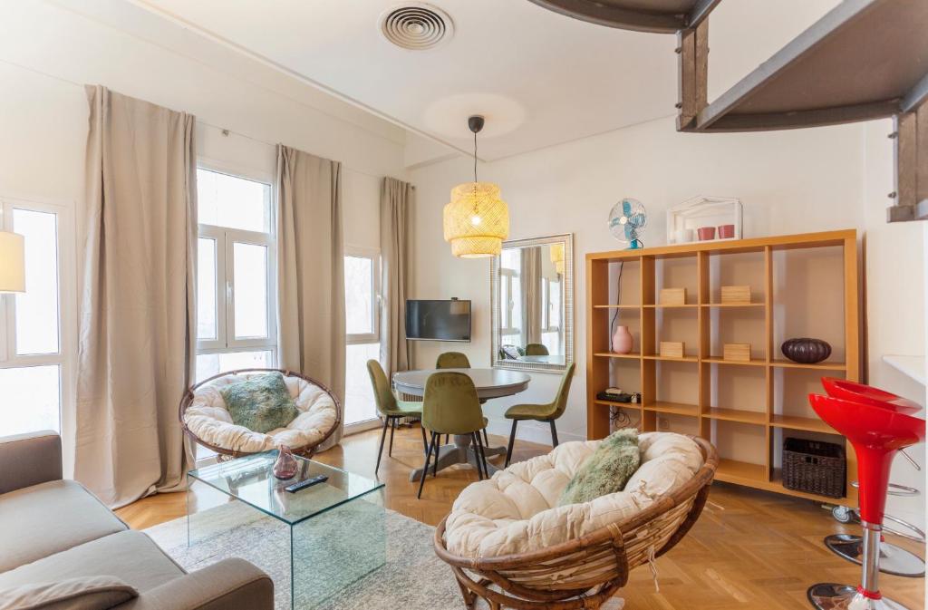 ein Wohnzimmer mit einem Tisch und Stühlen in der Unterkunft Apartamento Barquillo Duplex en Madrid in Madrid