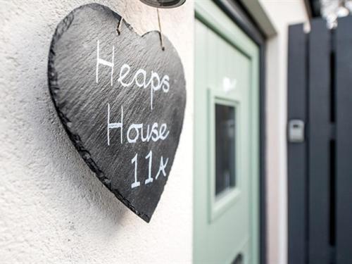 a heart shaped sign on the side of a building at Heaps House in Denby Dale