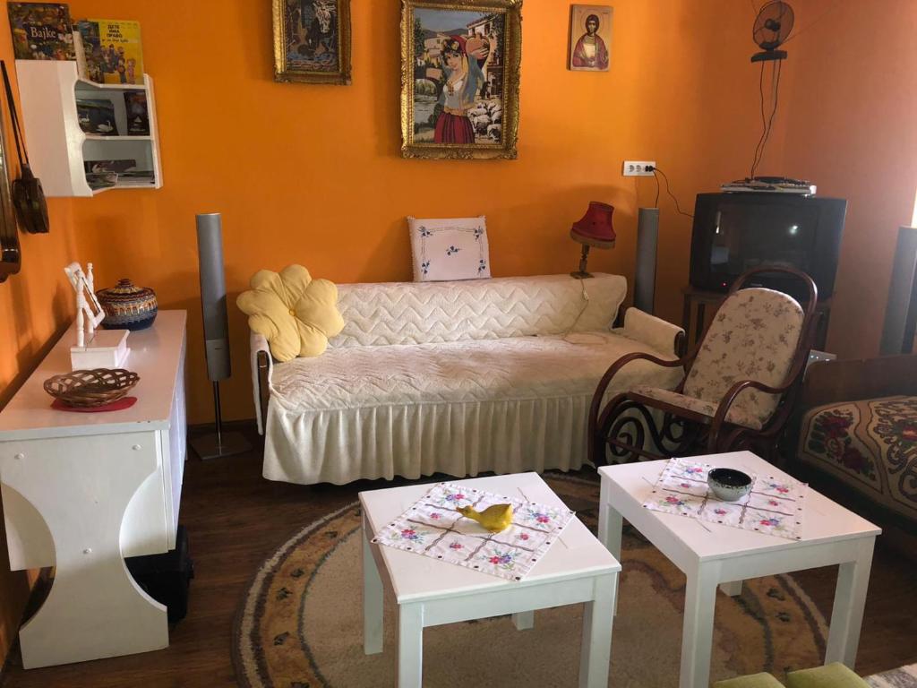 a living room with a couch and two tables at Salaš Gnijezdo in Bačka Palanka
