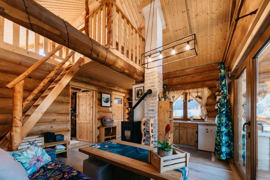 a log cabin bedroom with wooden walls and wooden beams at Szepit in Lutowiska