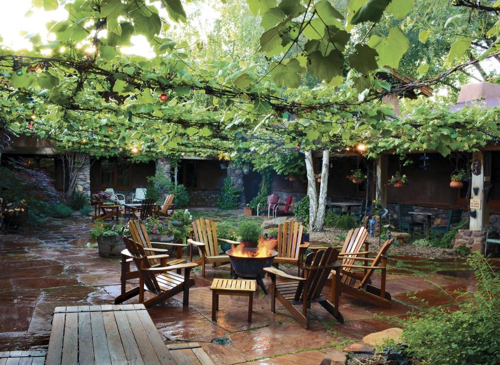 a group of chairs and tables in a garden at El Portal Sedona Hotel in Sedona