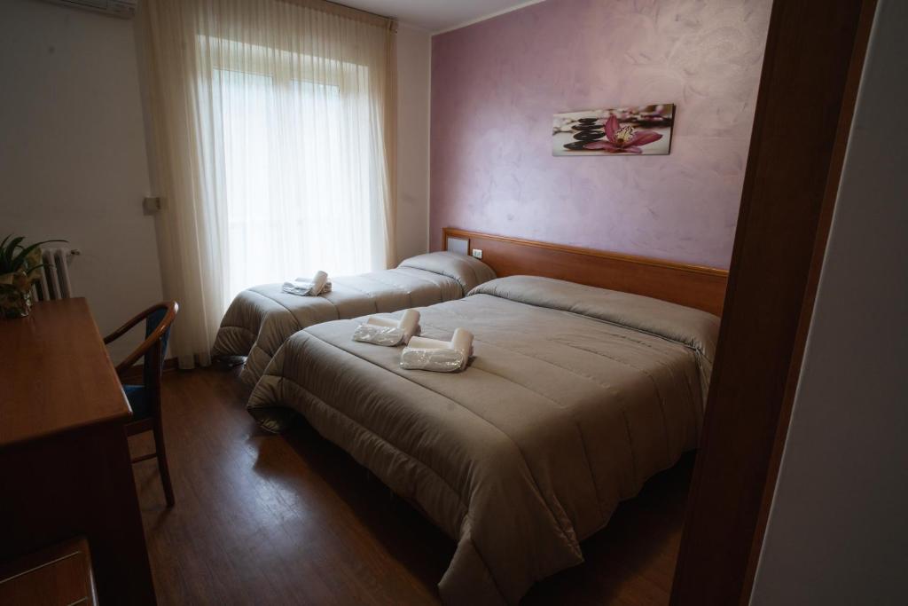 Postel nebo postele na pokoji v ubytování Hotel Tre Monti