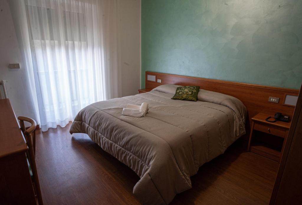 Postel nebo postele na pokoji v ubytování Hotel Tre Monti