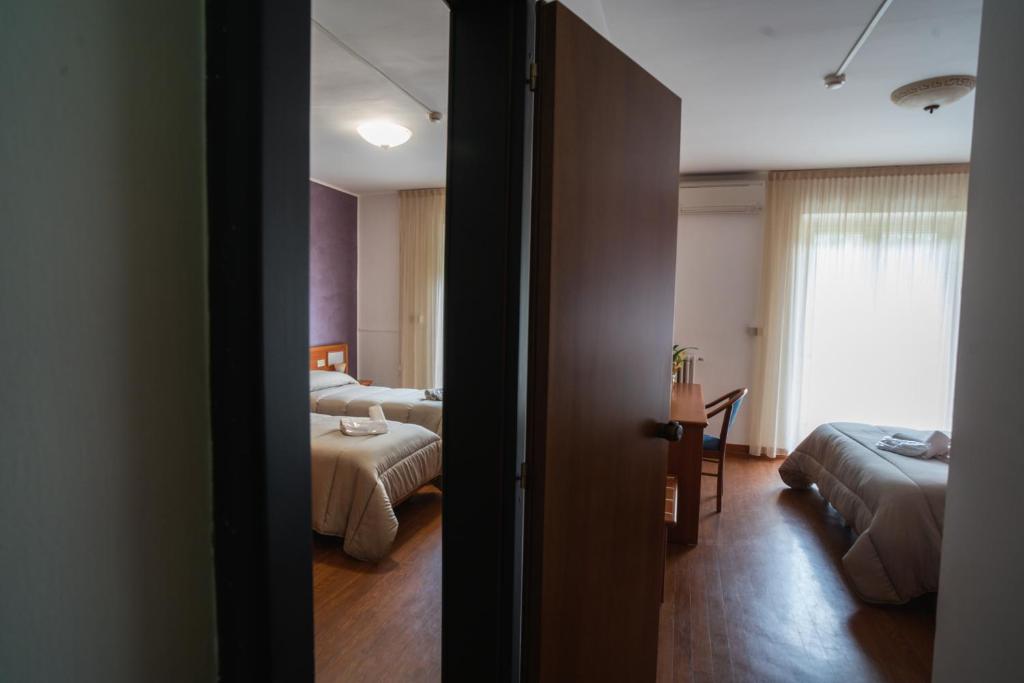 Postel nebo postele na pokoji v ubytování Hotel Tre Monti