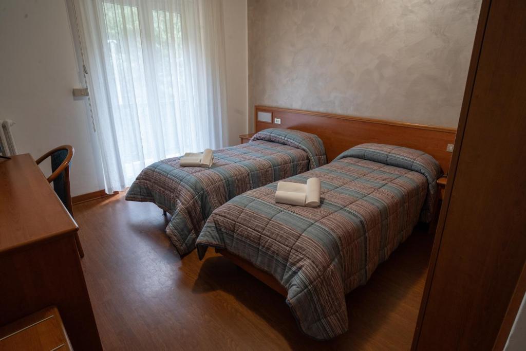 Postel nebo postele na pokoji v ubytování Hotel Tre Monti