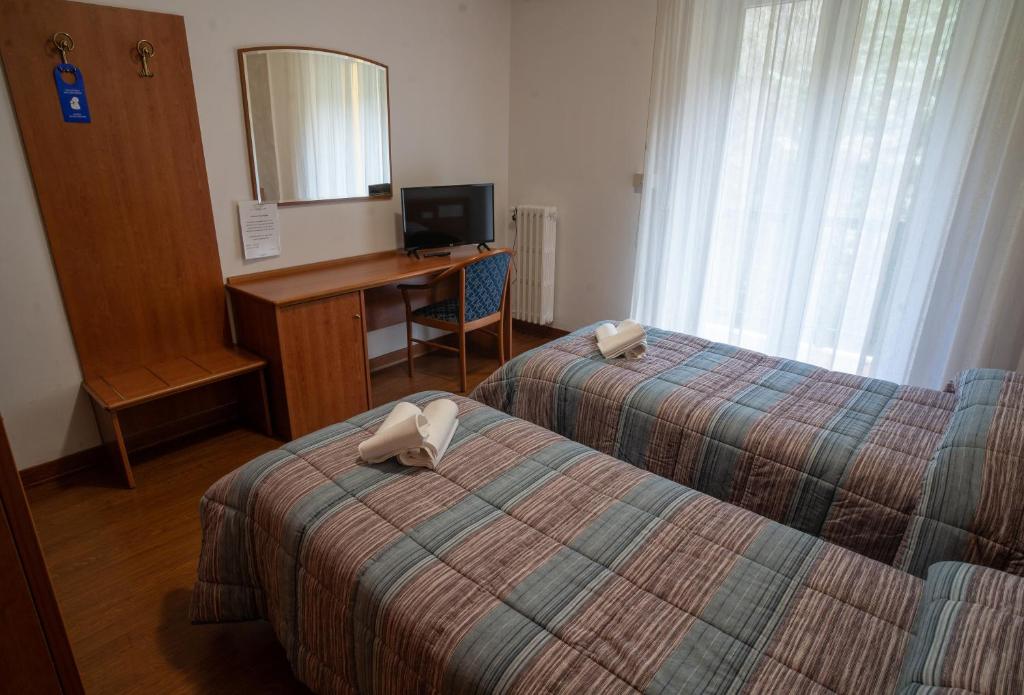Postel nebo postele na pokoji v ubytování Hotel Tre Monti