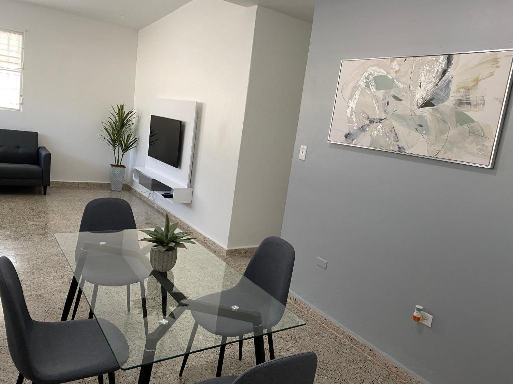 a living room with a glass table and chairs at San Juan Home in San Juan