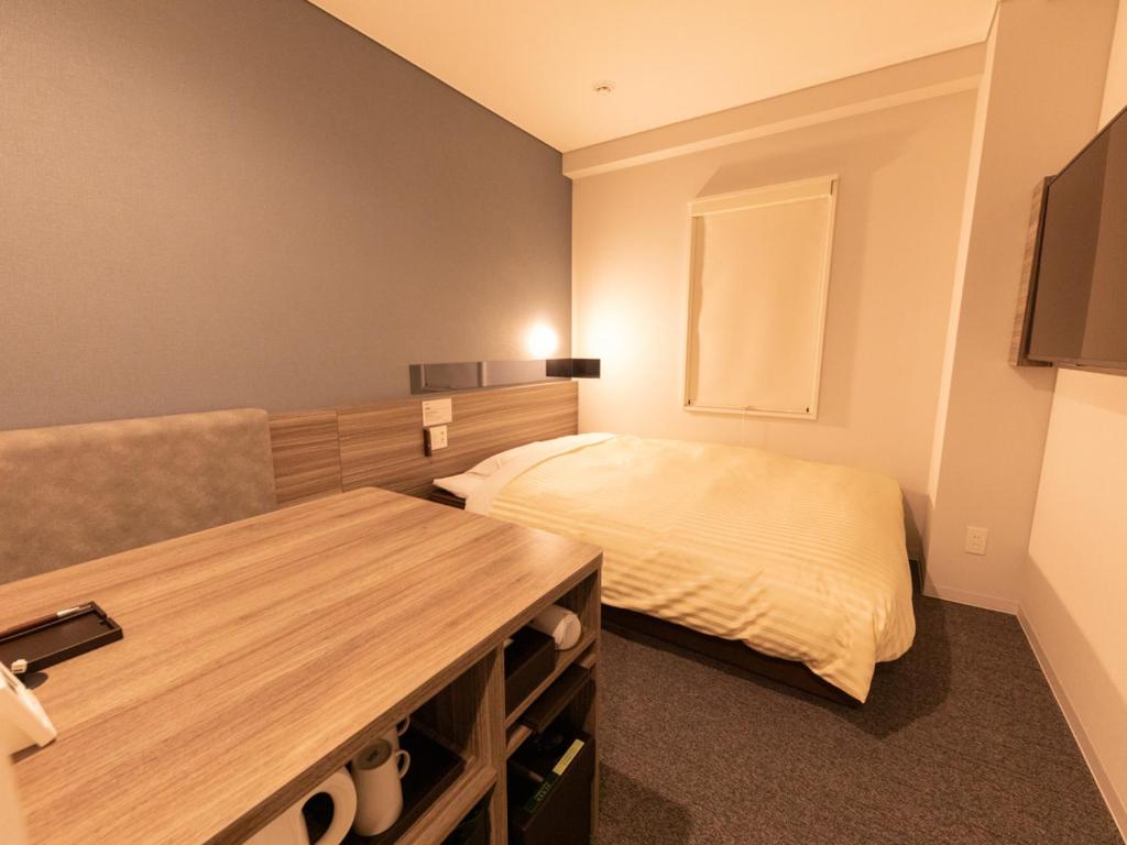 Postel nebo postele na pokoji v ubytování Super Hotel Ishikawa Nomineagari Smart Inter
