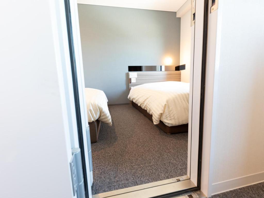 Postel nebo postele na pokoji v ubytování Super Hotel Ishikawa Nomineagari Smart Inter