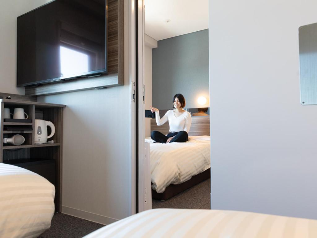 Postel nebo postele na pokoji v ubytování Super Hotel Ishikawa Nomineagari Smart Inter