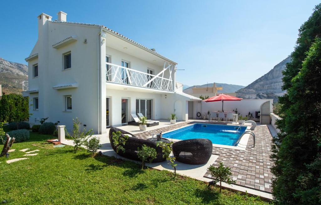 a villa with a swimming pool and a house at Villa Capitano 3 bedrooms w ensuite bathroom and heated pool in Žrnovnica
