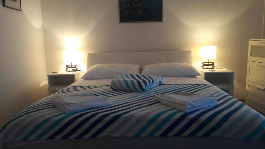 een slaapkamer met een bed met 2 kussens erop bij apartman-maja-krk in Krk