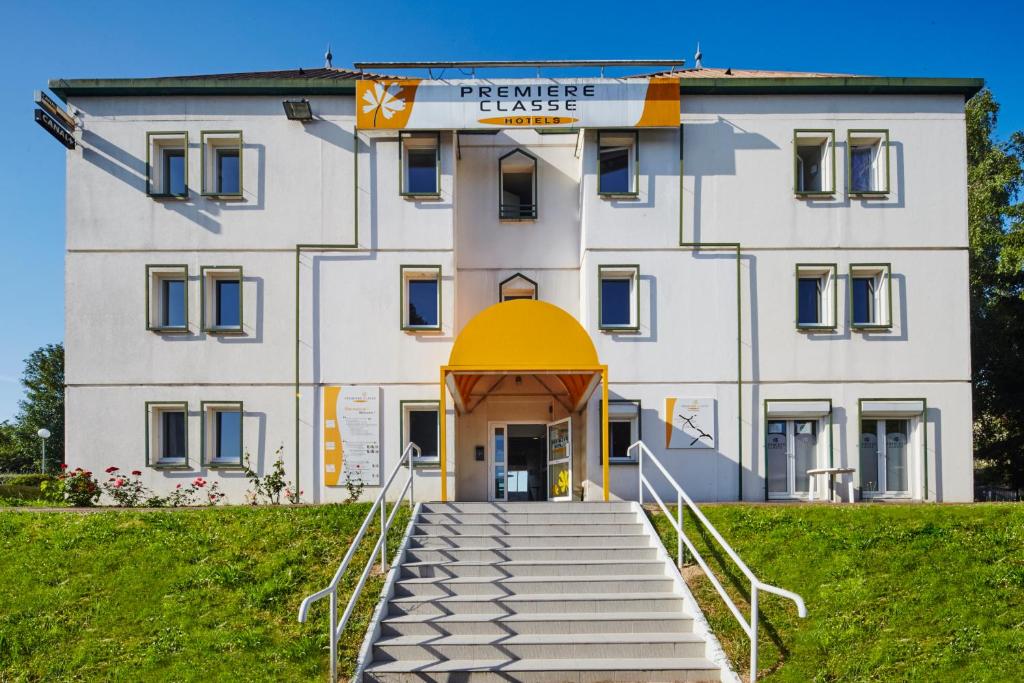 a white building with a staircase in front of it at Premiere Classe Cergy Saint Christophe in Cergy