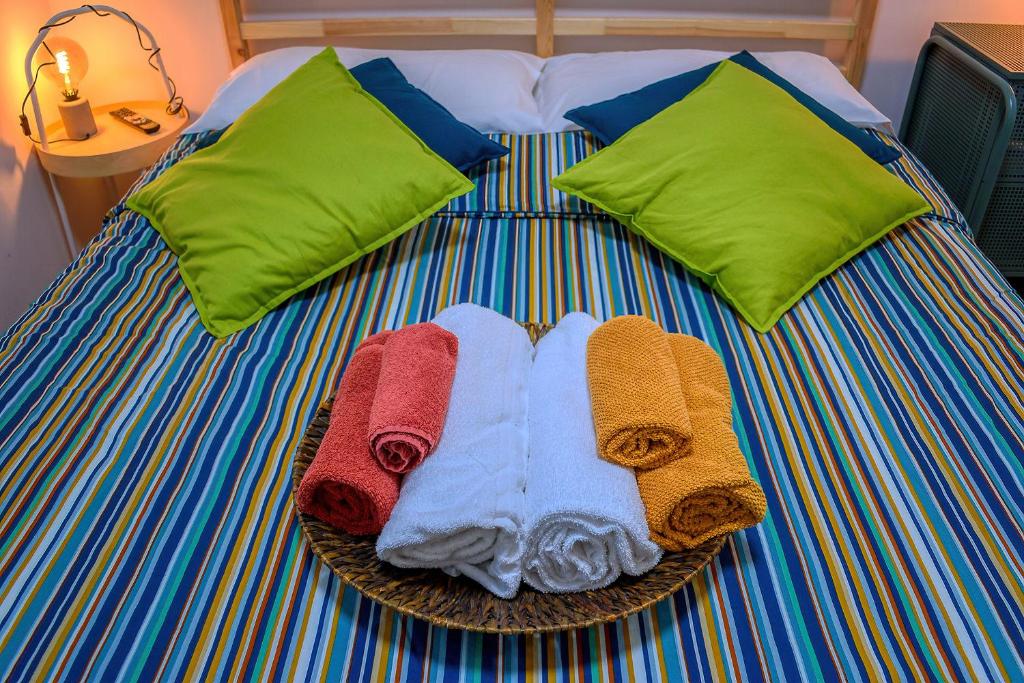 a bed with towels and pillows on it at Aduepassi in Ascoli Piceno