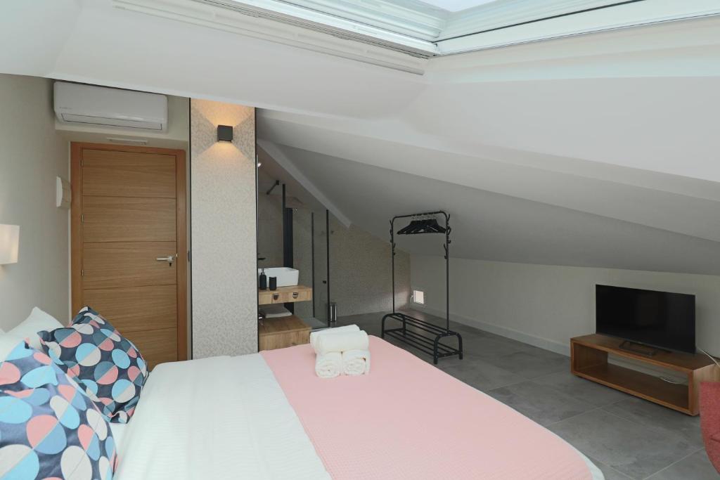 a bedroom with a bed and a television in it at La Panadería in El Rompido