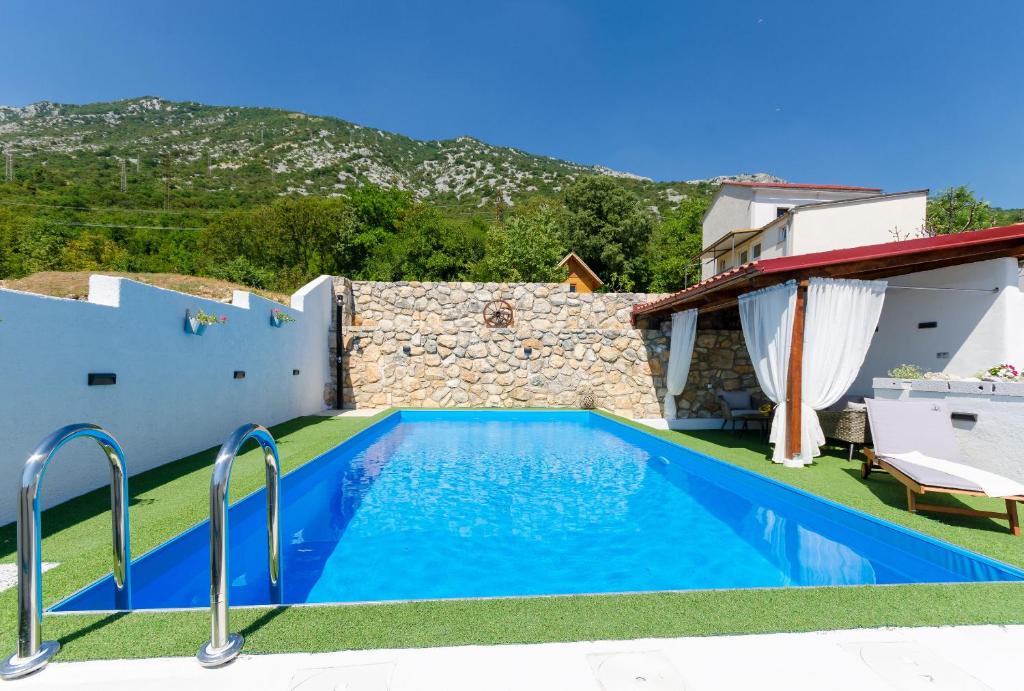 a swimming pool in the backyard of a villa at House Bozica with sauna and pool in Tribalj