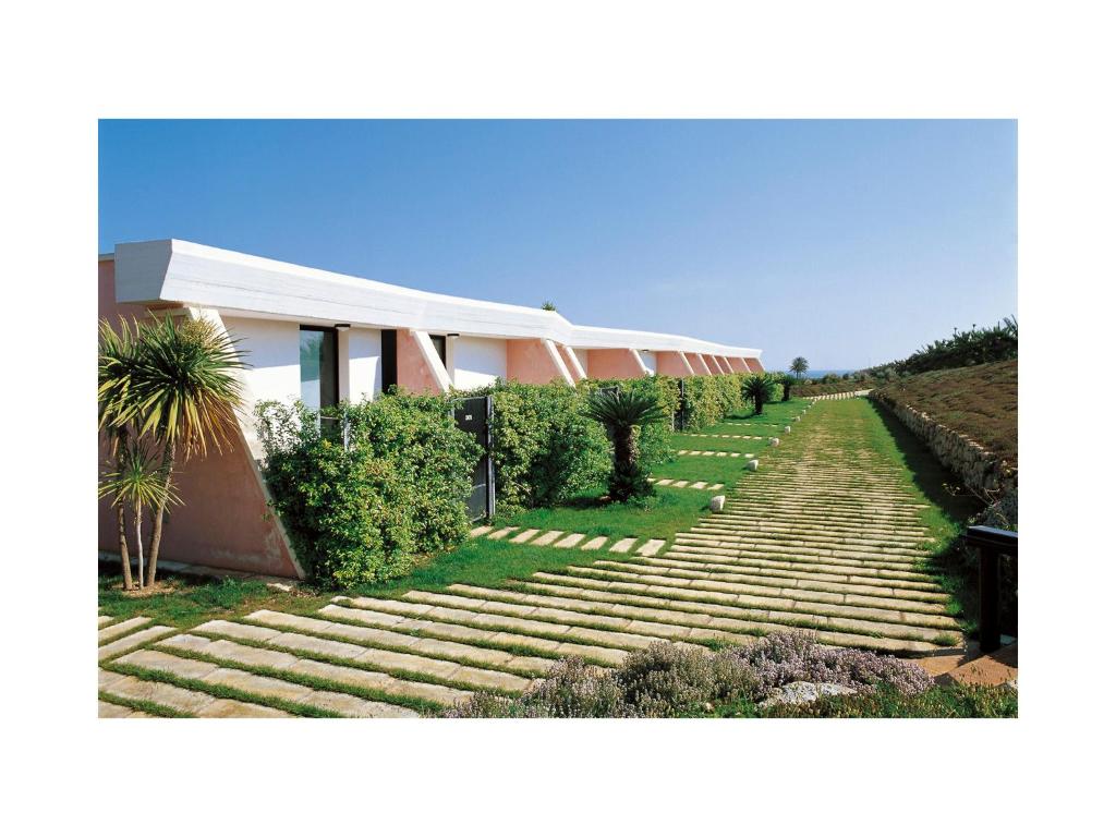 a house with steps leading up to a building at Grand Hotel Masseria Santa Lucia in Ostuni