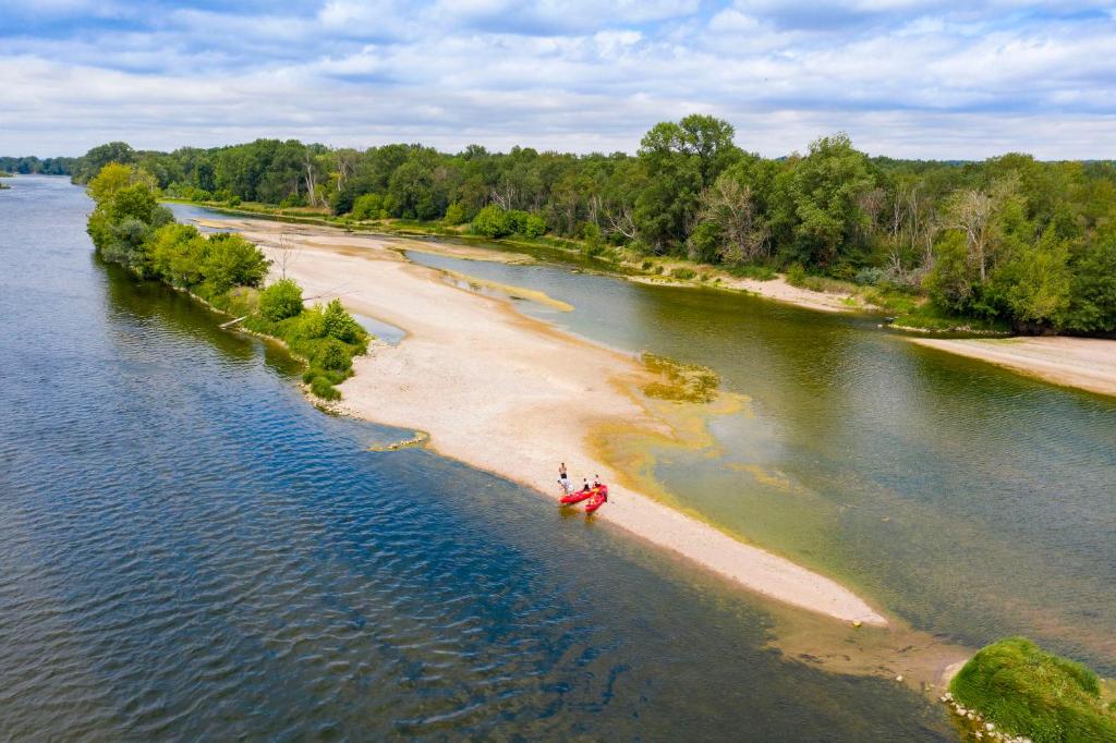 deux personnes se tiennent sur une plage dans l'eau dans l'établissement Camping de Montlouis-sur-Loire, à Montlouis-sur-Loire