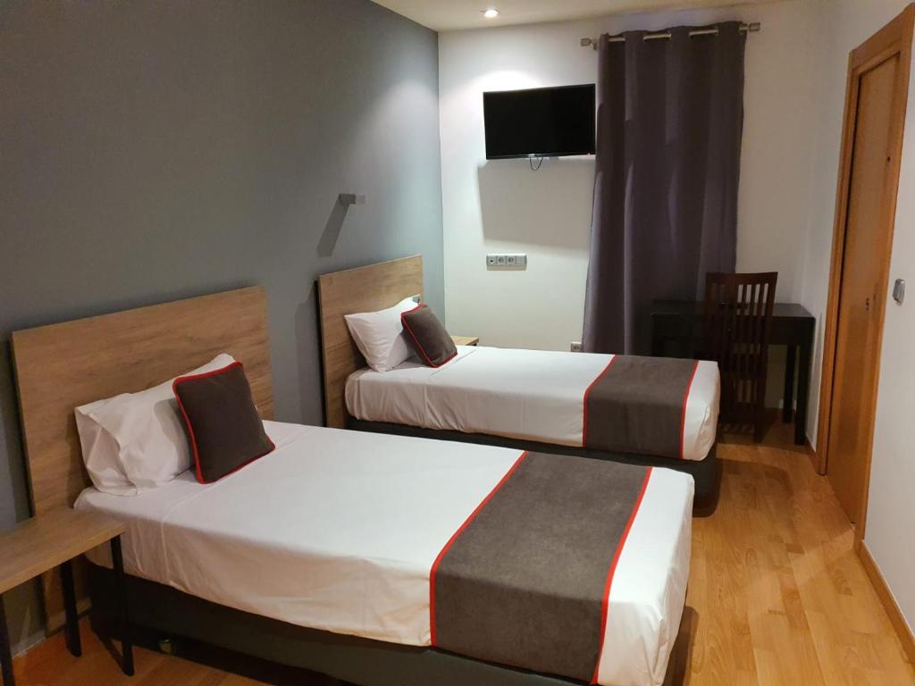 Postel nebo postele na pokoji v ubytování Hospedium Hotel Vittoria Colonna