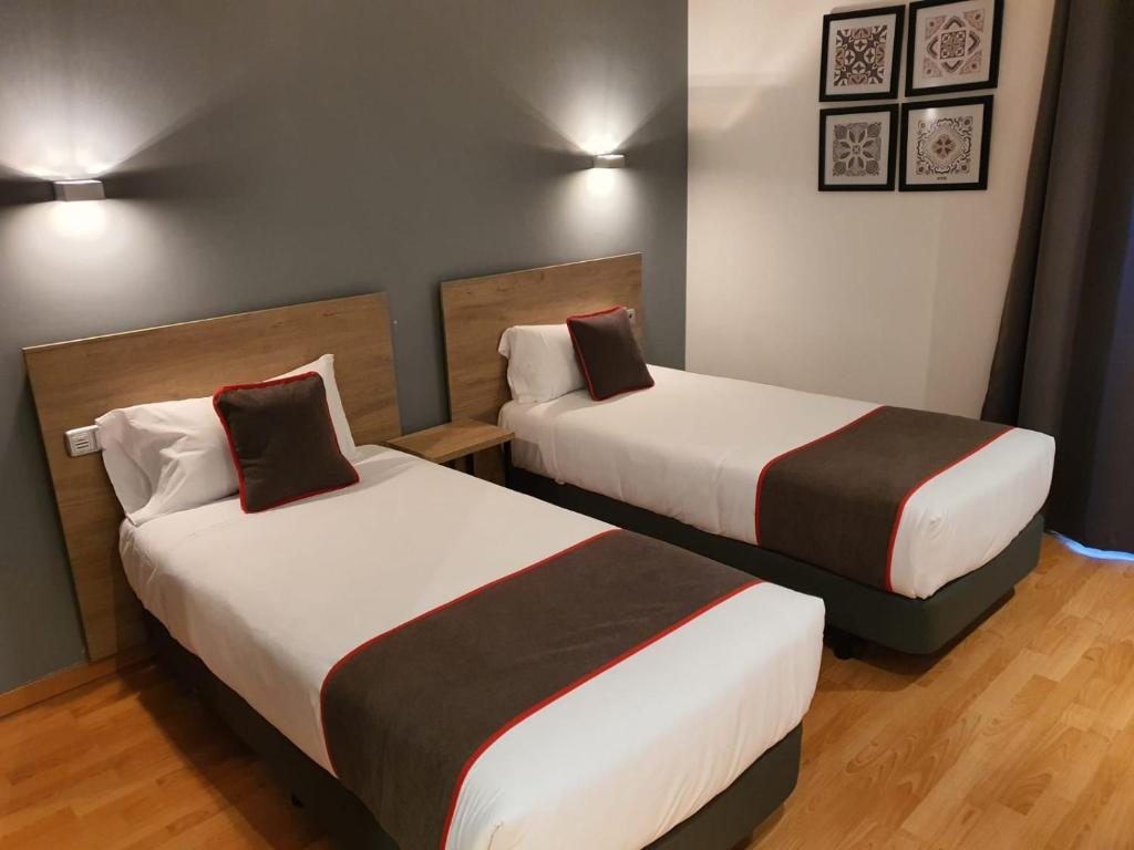 Postel nebo postele na pokoji v ubytování Hospedium Hotel Vittoria Colonna