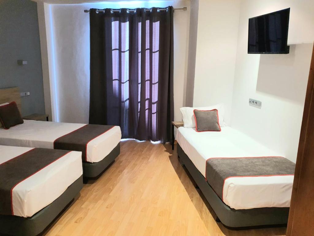 Postel nebo postele na pokoji v ubytování Hospedium Hotel Vittoria Colonna