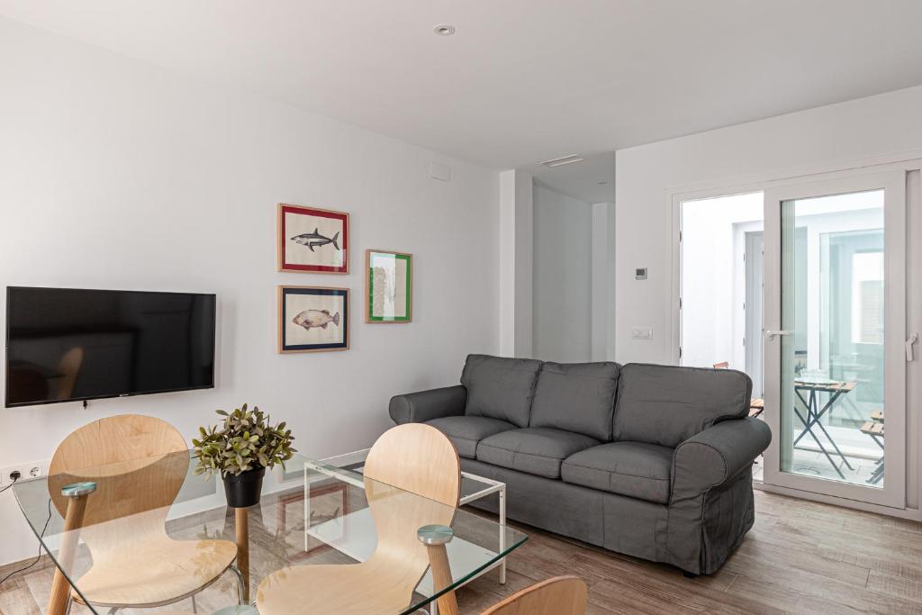 Televízia a/alebo spoločenská miestnosť v ubytovaní Apartamentos Wamba