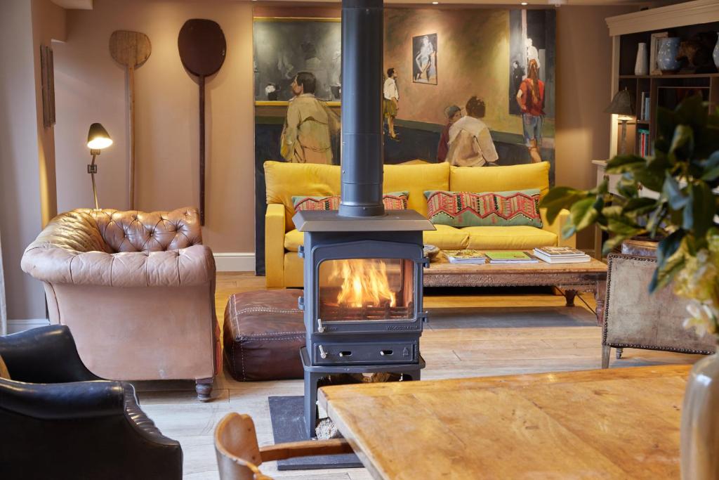 a living room with a wood stove in a living room at The Tower Rooms in Fakenham