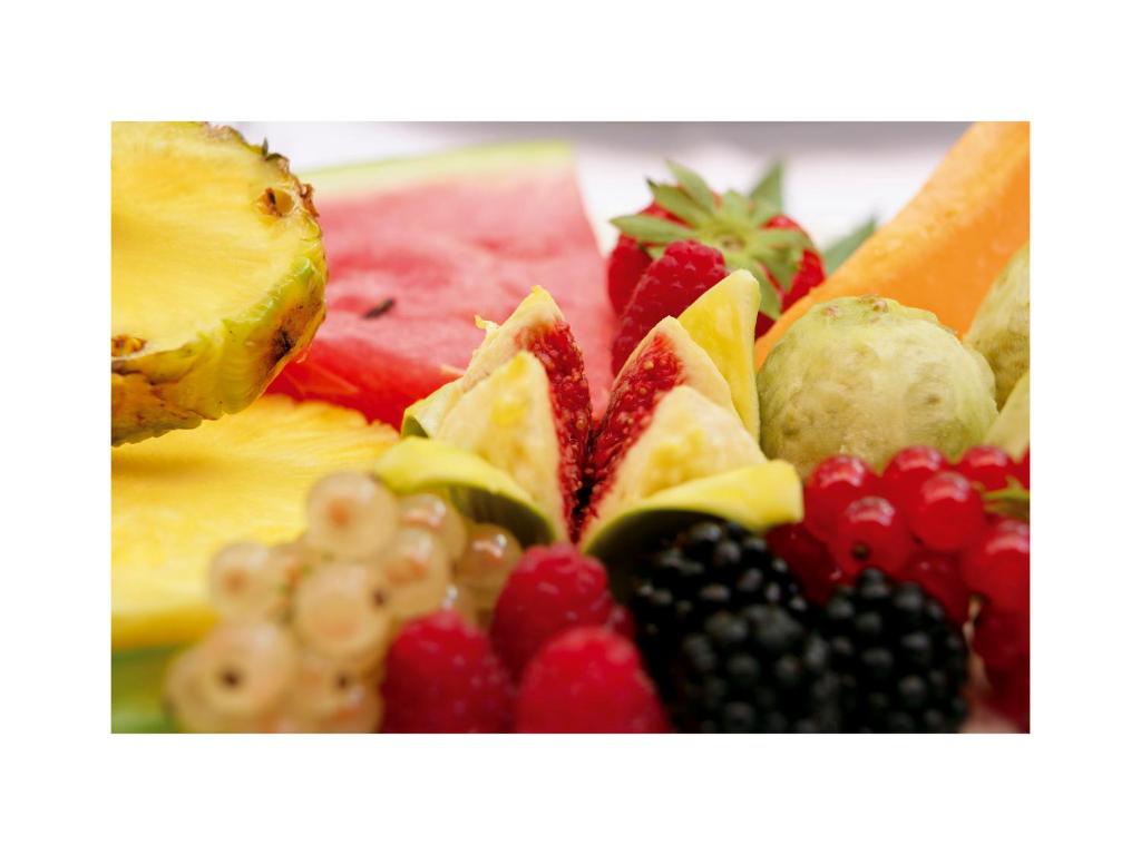 a pile of fruit sitting on a plate at Grand Hotel Masseria Santa Lucia in Ostuni