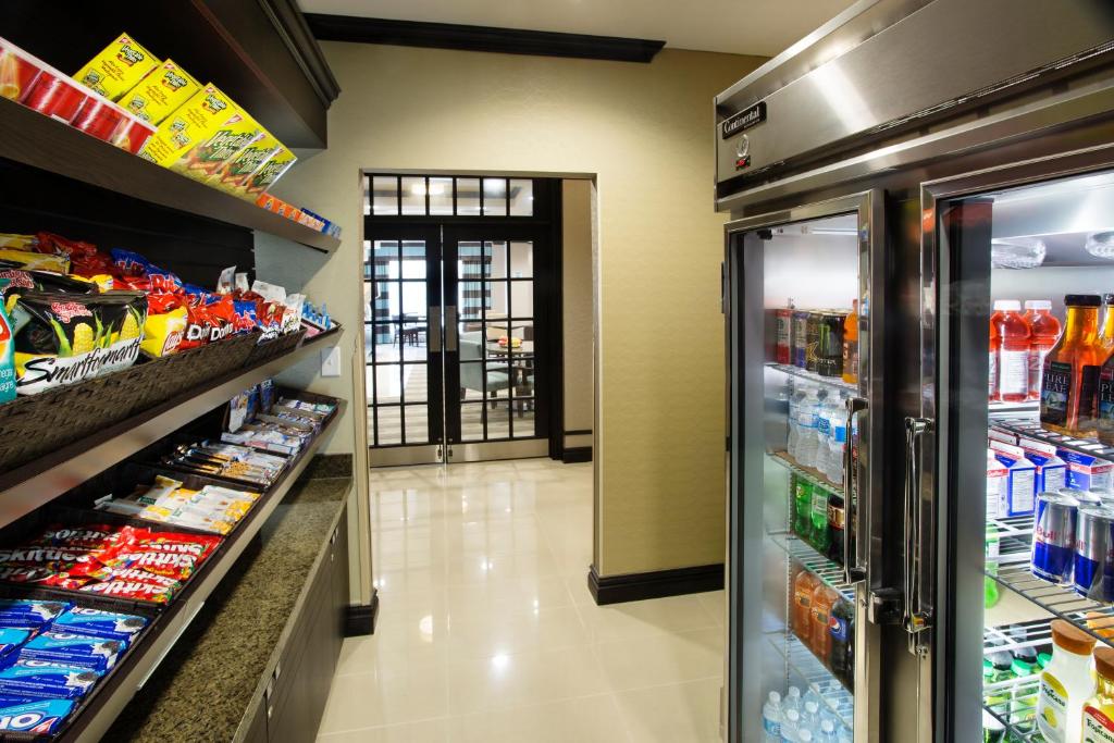 an aisle of a grocery store with a refrigerator at Holiday Inn Express & Suites Ottawa West - Nepean by IHG in Ottawa