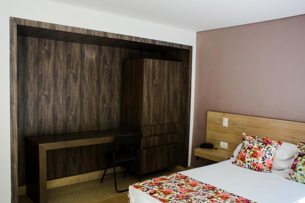 Postel nebo postele na pokoji v ubytování Hotel Poma Rosa
