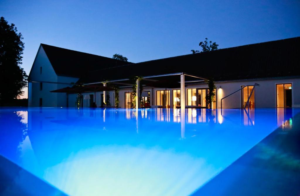 a swimming pool with blue lights in front of a building at B&O Parkhotel in Bad Aibling