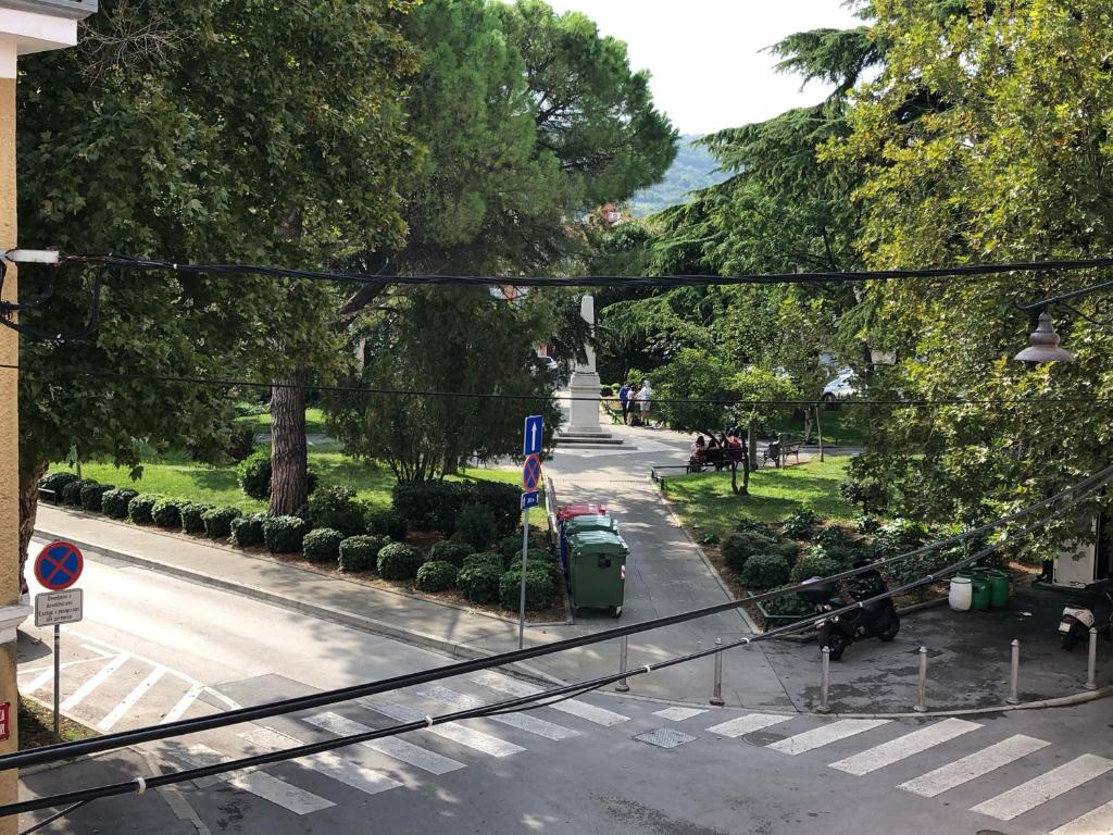 a view of a street with trees and a sidewalk at Apartments & Rooms Nardin in Izola