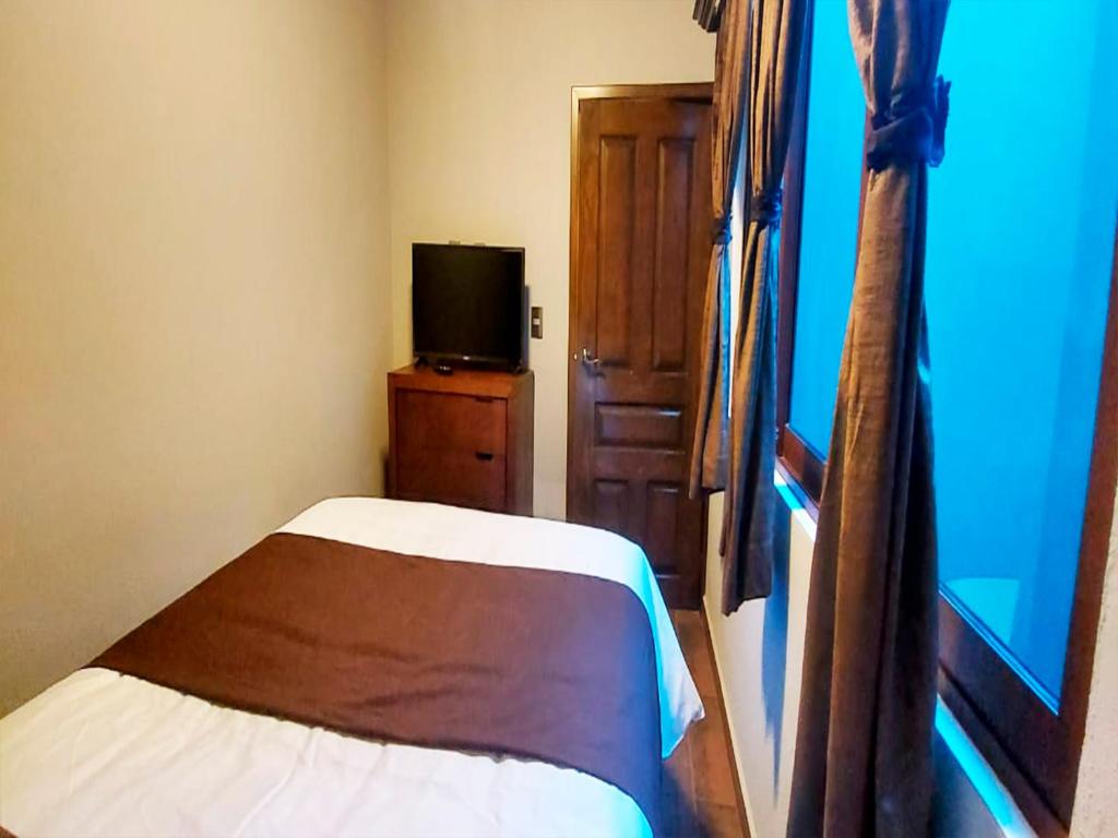 Postel nebo postele na pokoji v ubytování Hotel Suites La Fortuna
