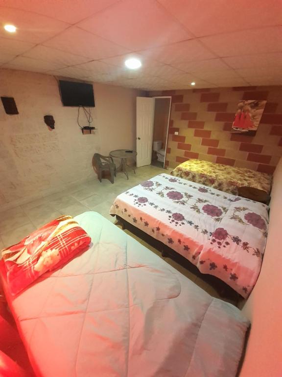 Postel nebo postele na pokoji v ubytování Hospedaje Rampolla's