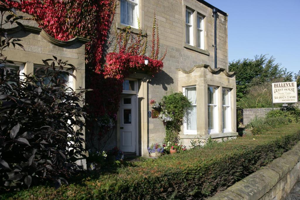 a house with flowers on the side of it at Bellevue Guest House in Kelso