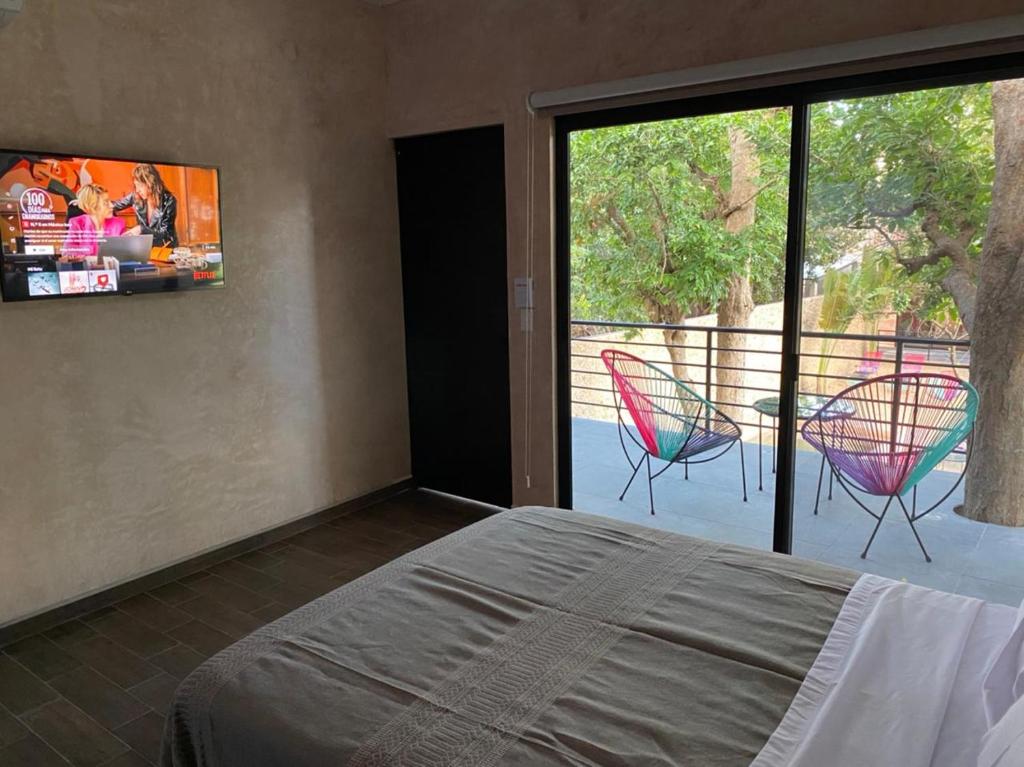 Llit o llits en una habitació de Hotelito YUM KAAX