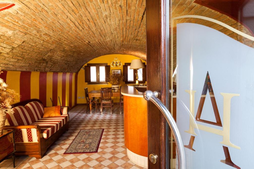 a living room with a couch and a table at Hotel Antica Fonte in Brescia