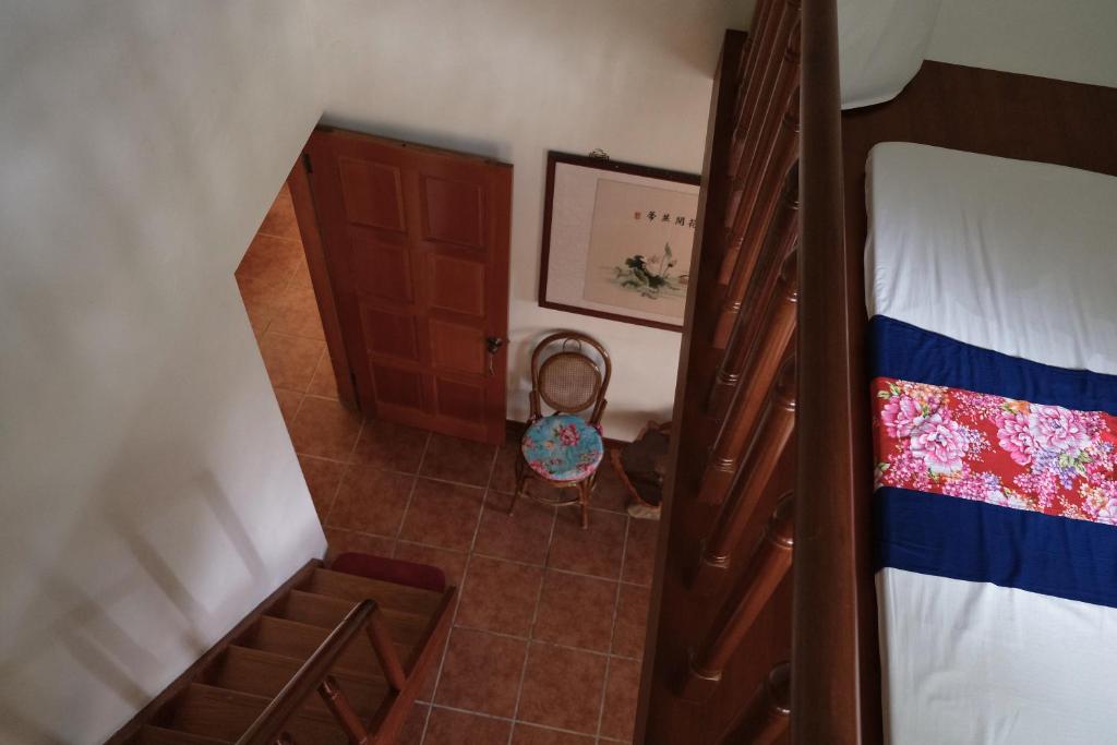 Postel nebo postele na pokoji v ubytování Wisdom Garden Home Stay