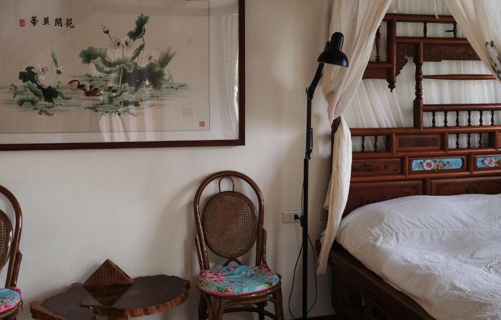 Postel nebo postele na pokoji v ubytování Wisdom Garden Home Stay