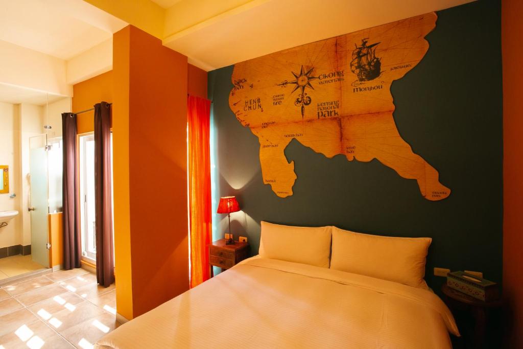 a bedroom with a bed with a map on the wall at Blue Ocean Sunny BS in Checheng