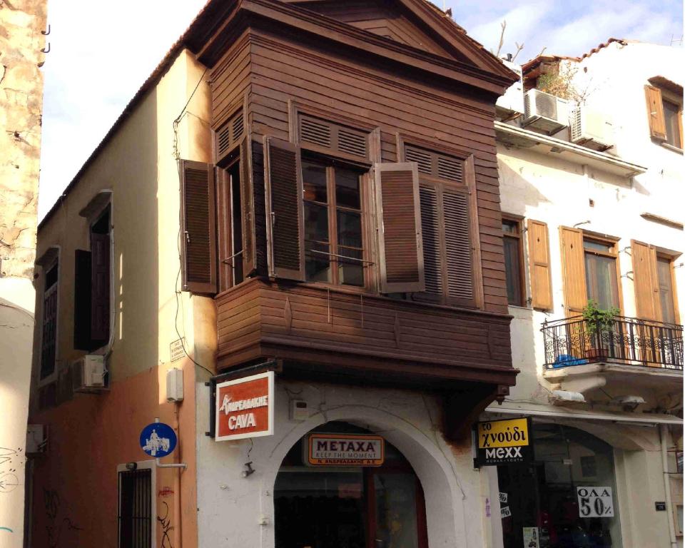 a wooden building with a sign in front of it at Rethymno House in Rethymno Town