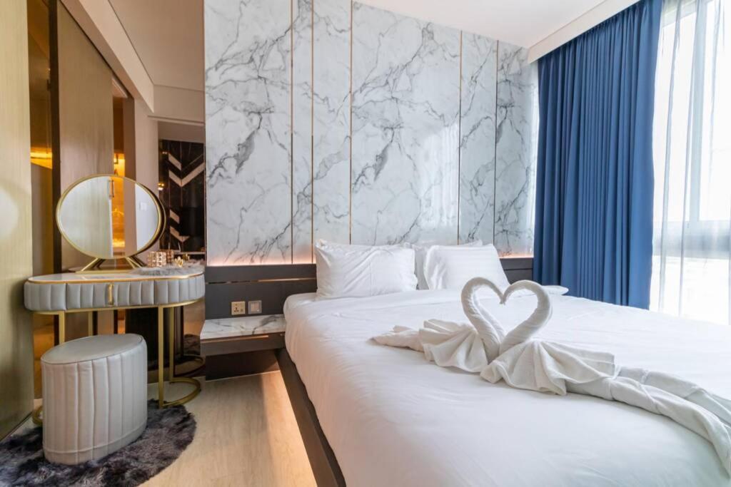 a hotel room with two beds with a heart on it at Veranda Pattaya Luxury Design Balcony with seaview in Na Jomtien