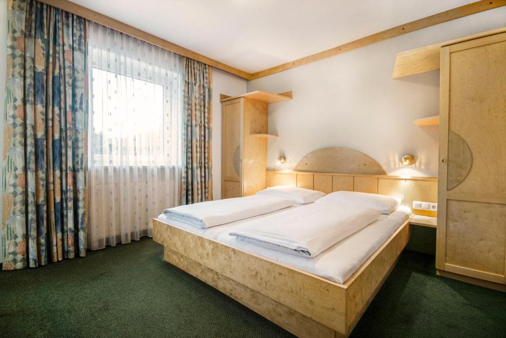 Postel nebo postele na pokoji v ubytování Apartpension Kappacher
