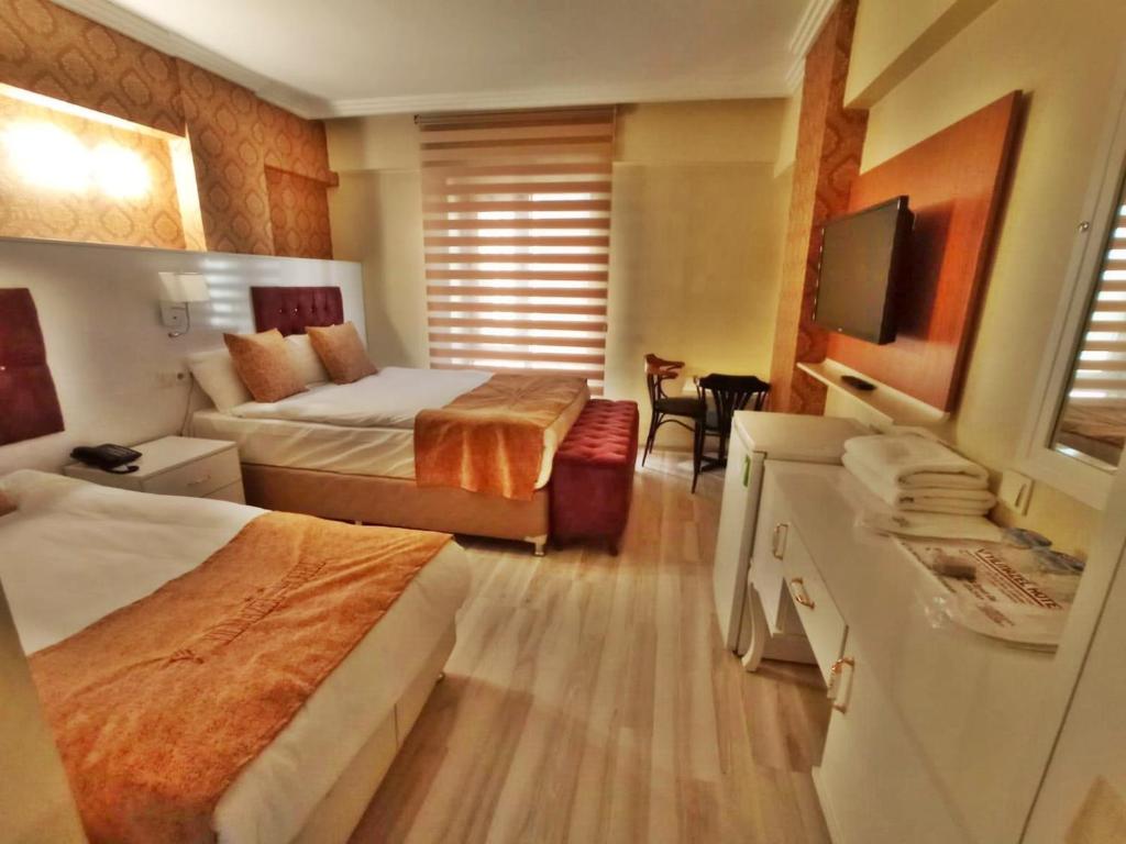 Säng eller sängar i ett rum på Yilmazel Hotel