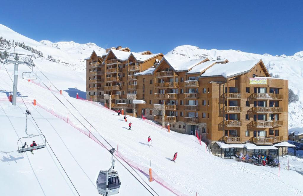 una estación de esquí con un remonte en la nieve en Résidence Odalys Rochebrune, en Orcières