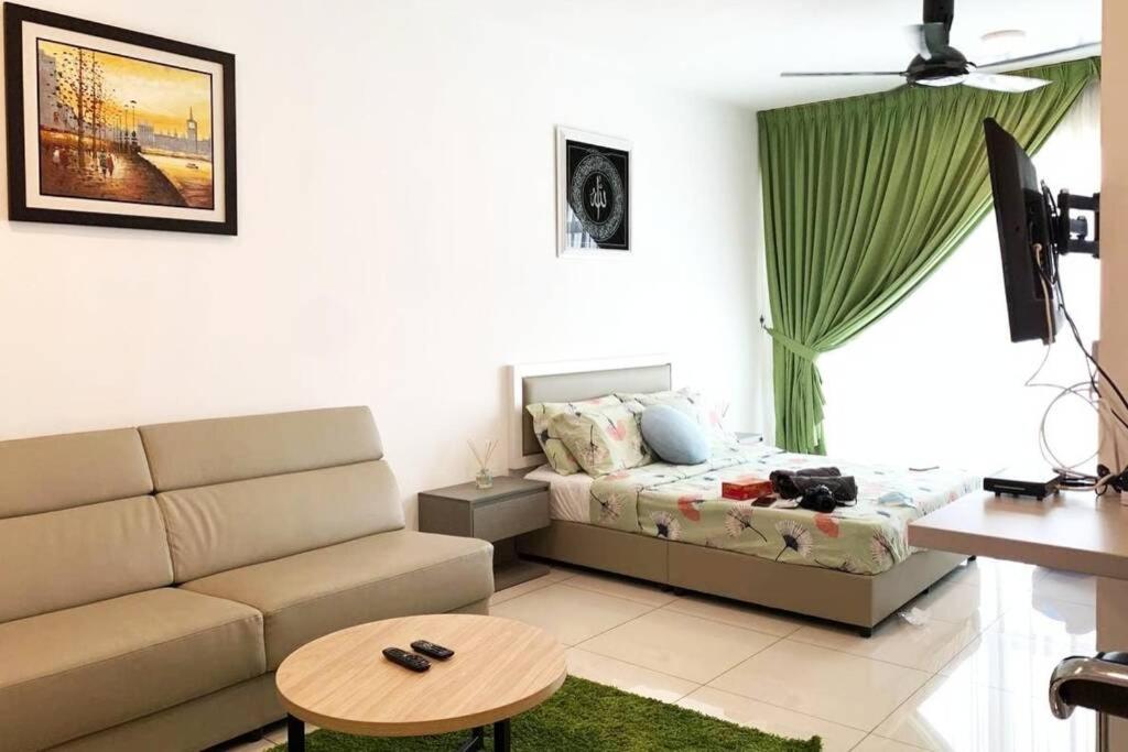 a living room with a bed and a couch at ZY Studio @ EVO SOHO Bangi [ASTRO WiFi NETFLIX] in Bangi