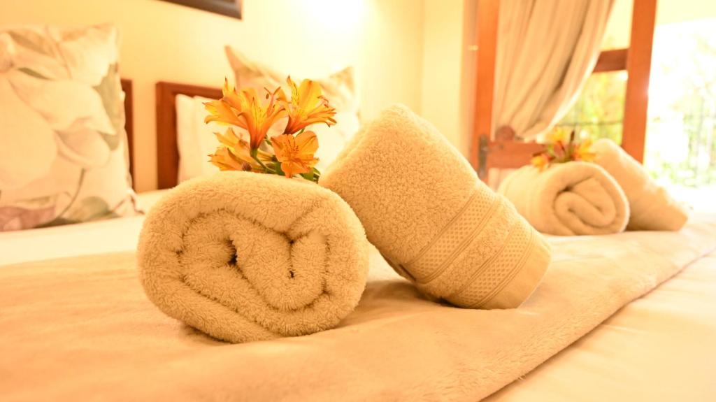 a couple of towels sitting on a bed at Lamor Guest House in Middelburg